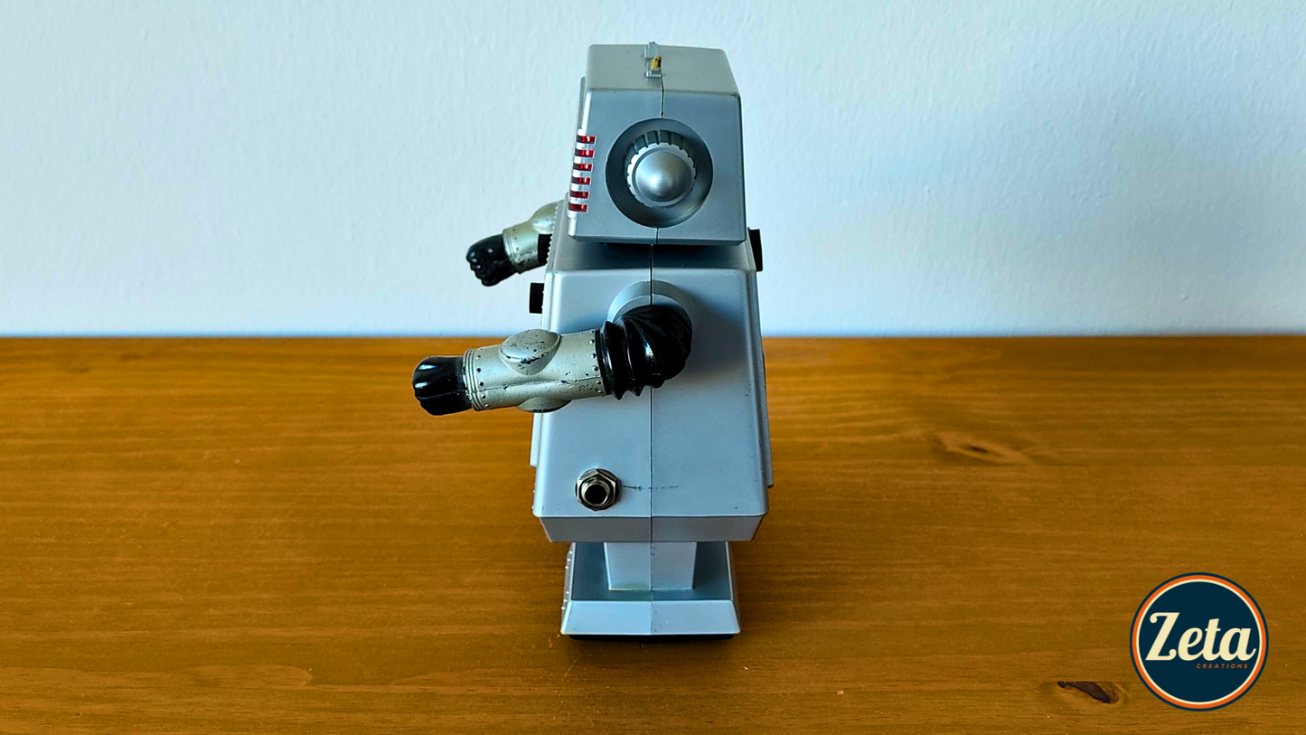 Side profile of ASTROMAN portable guitar amp with retro robot design