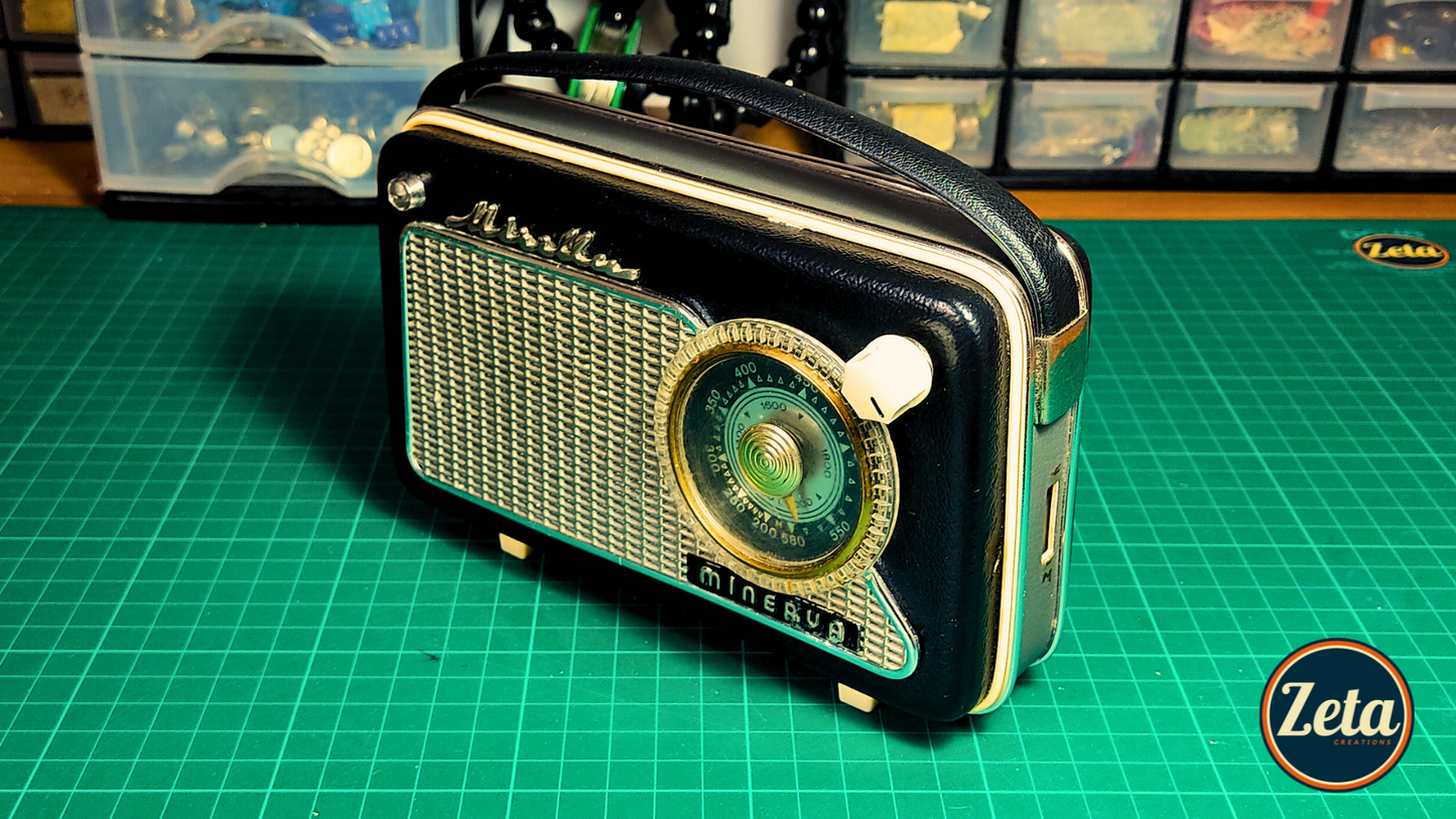 Angled view of MINERVA portable guitar amplifier crafted from French radio

