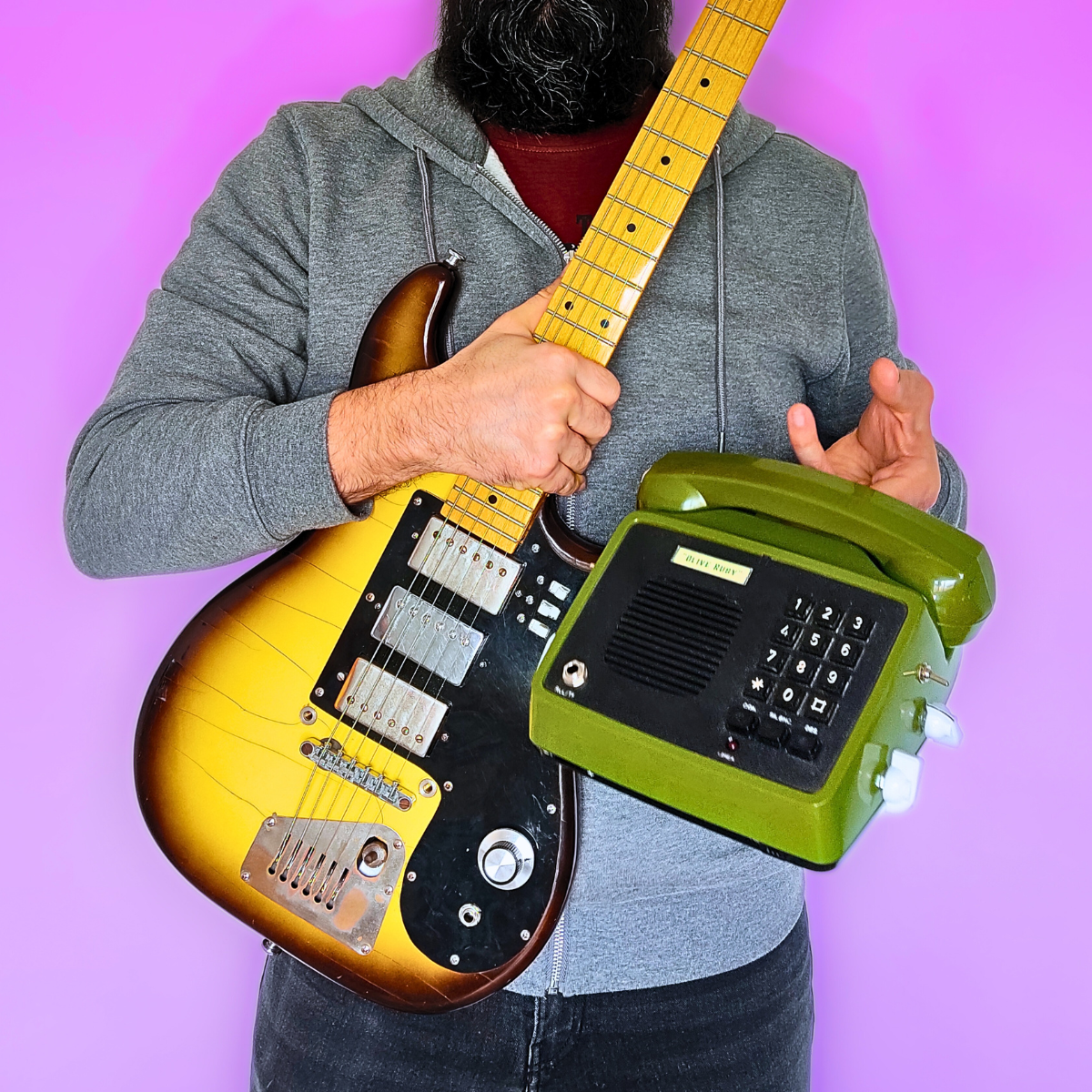 Front view of OLIVE RUBY TC portable guitar amp – 1980s phone converted into amp with tremolo and microphone

